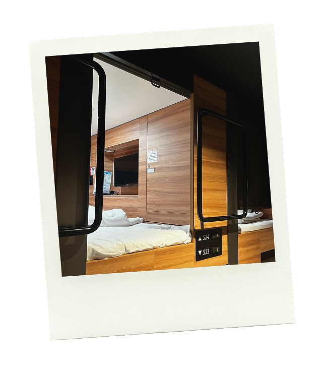 Polaroid of a capsule hotel bed